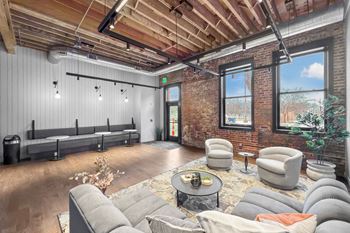 A room with a brick wall and a wooden ceiling.